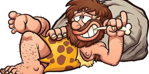 スペインの岩の上に横たわる漫画の穴居人。 スペインの岩の上に横たわる漫画の穴居人。