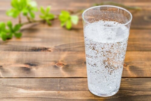 スペインの木のテーブルの上に水の入ったグラス。 スペインの木のテーブルの上に水の入ったグラス。