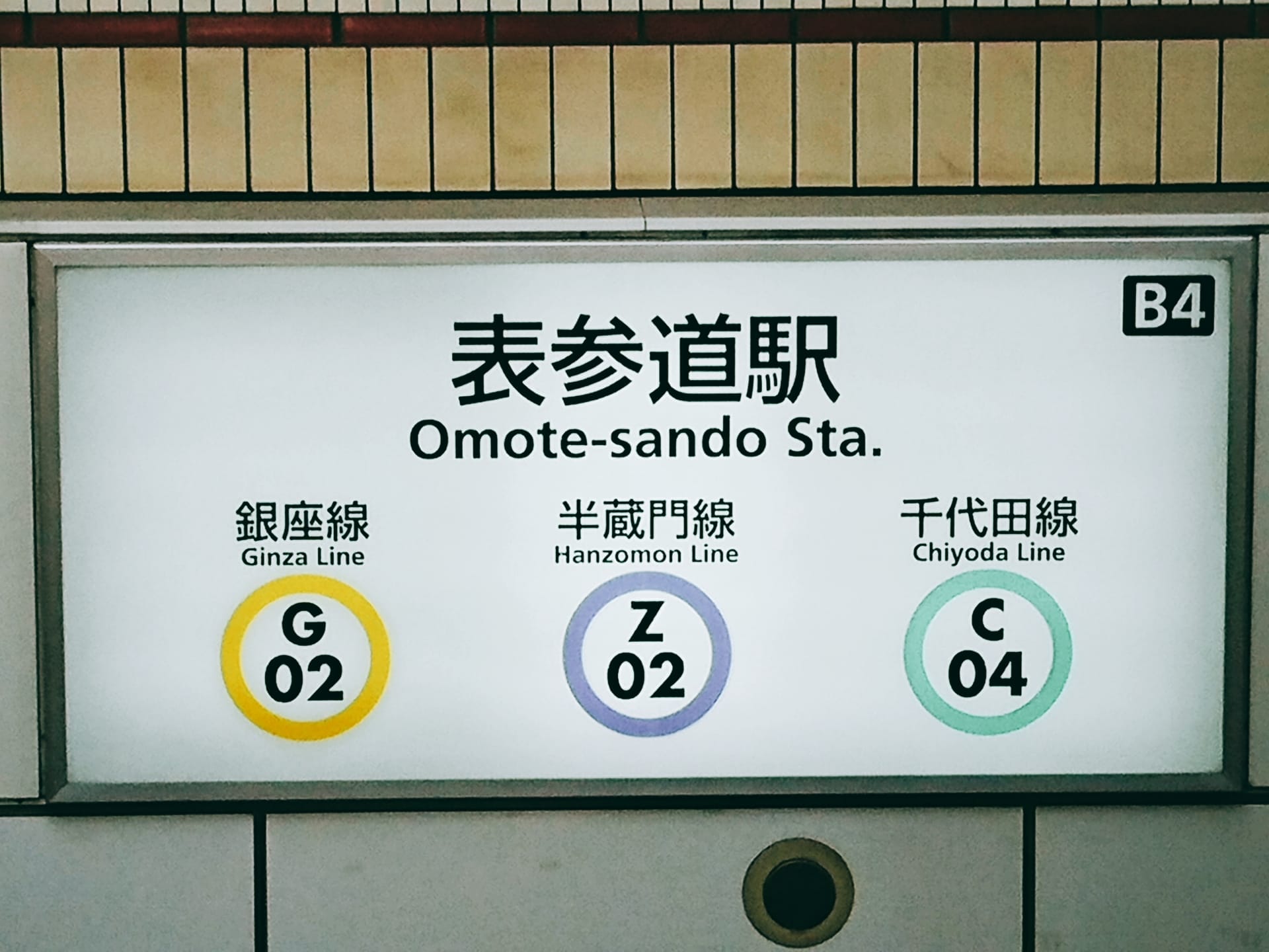 銀座線（G02）、半蔵門線（Z02）、千代田線（C04）のロゴが表示された表参道駅の標識。.
